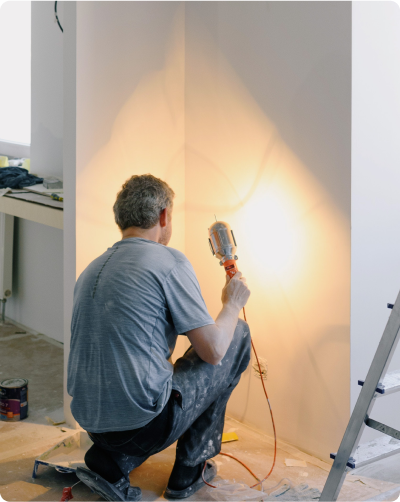 Painter shining light on painted wall