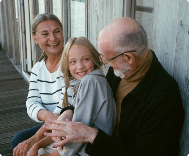 Young girl laughing with grandparents